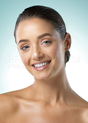 Buy stock photo Shot of a young female standing against a blue background