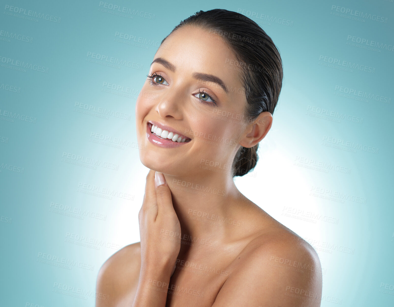 Buy stock photo Shot of a young female touching a her soft skin against a blue background