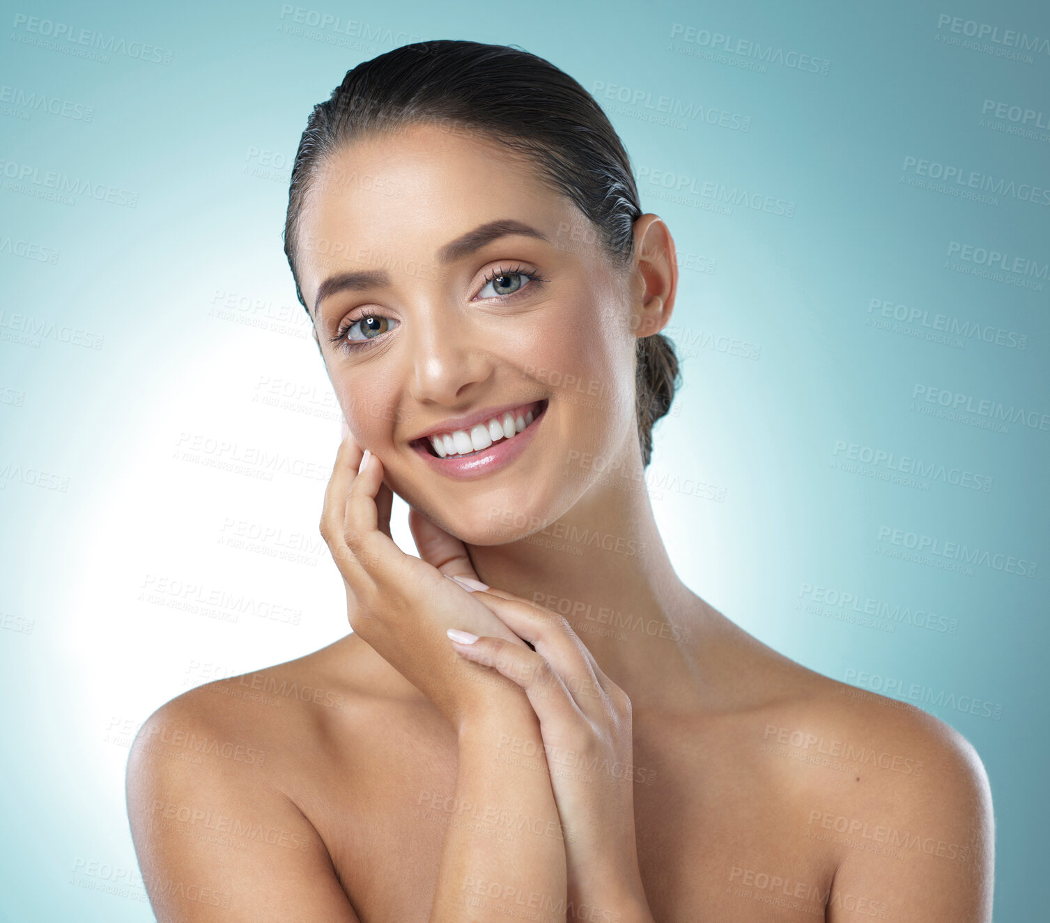 Buy stock photo Shot of a young female touching a her soft skin against a blue background