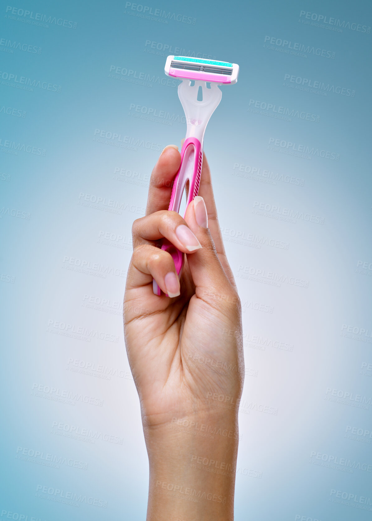 Buy stock photo Cropped shot of an unrecognisable woman holding a shaving stick against a blue background in the studio