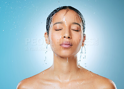 Buy stock photo Shot of an attractive young woman posing against a blue background in the studio