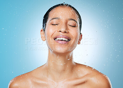 Buy stock photo Shot of an attractive young woman posing against a blue background in the studio