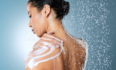 Buy stock photo Shot of an attractive young woman showering against a blue background