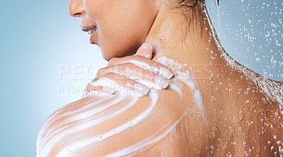 Buy stock photo Cropped shot of an unrecognisable woman showering against a blue background