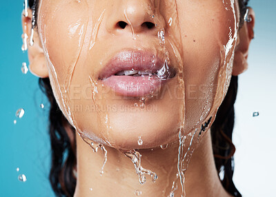 Buy stock photo Cropped shot of an unrecognisable woman posing against a blue background while taking a shower