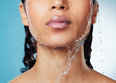 Buy stock photo Cropped shot of an unrecognisable woman posing against a blue background while taking a shower