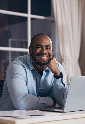 Buy stock photo Shot of a young businessman working using his laptop at night