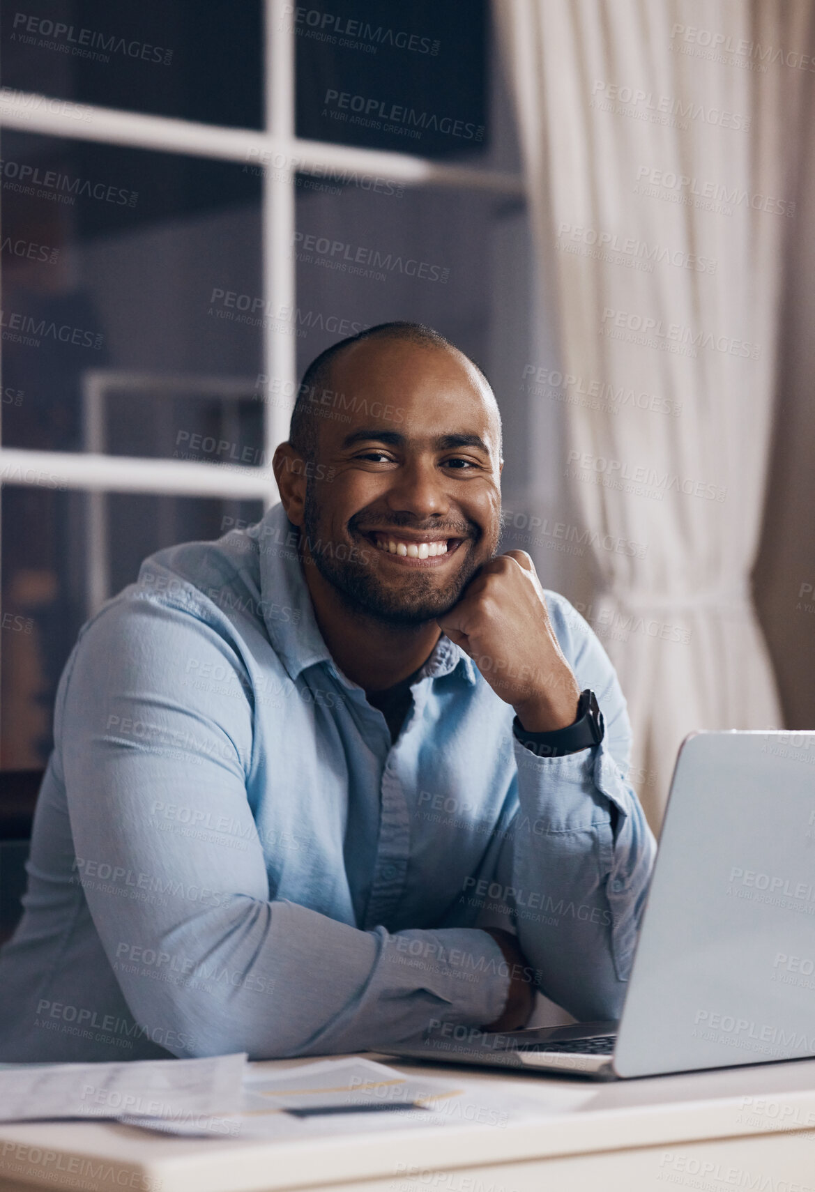 Buy stock photo Shot of a young businessman working using his laptop at night