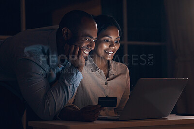 Buy stock photo Shot of a young man watching his wife make online payments using her bank card