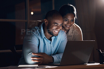 Buy stock photo Shot of a young woman checking in on her husband as he works on his laptop
