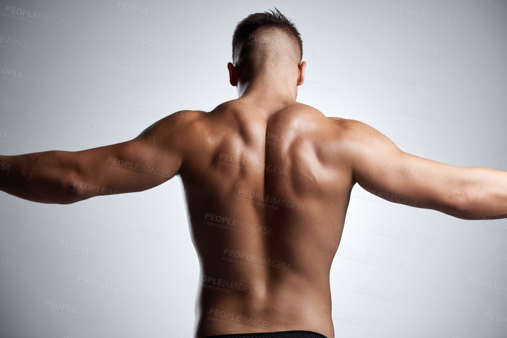 Buy stock photo Back, flex and bodybuilder in studio with muscle, fitness and strong from training or exercise. Healthy, person and model stretching arms on background or mockup with wellness from workout in gym