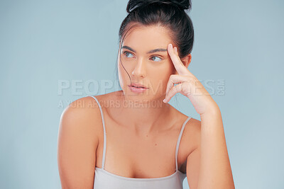 Buy stock photo Thinking, woman and skincare in studio with natural beauty, cosmetics and wellness on blue backdrop. Daydreaming, face and female person isolated by background for dermatology, self care and routine