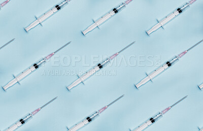 Buy stock photo Shot of a group of syringes against a blue background