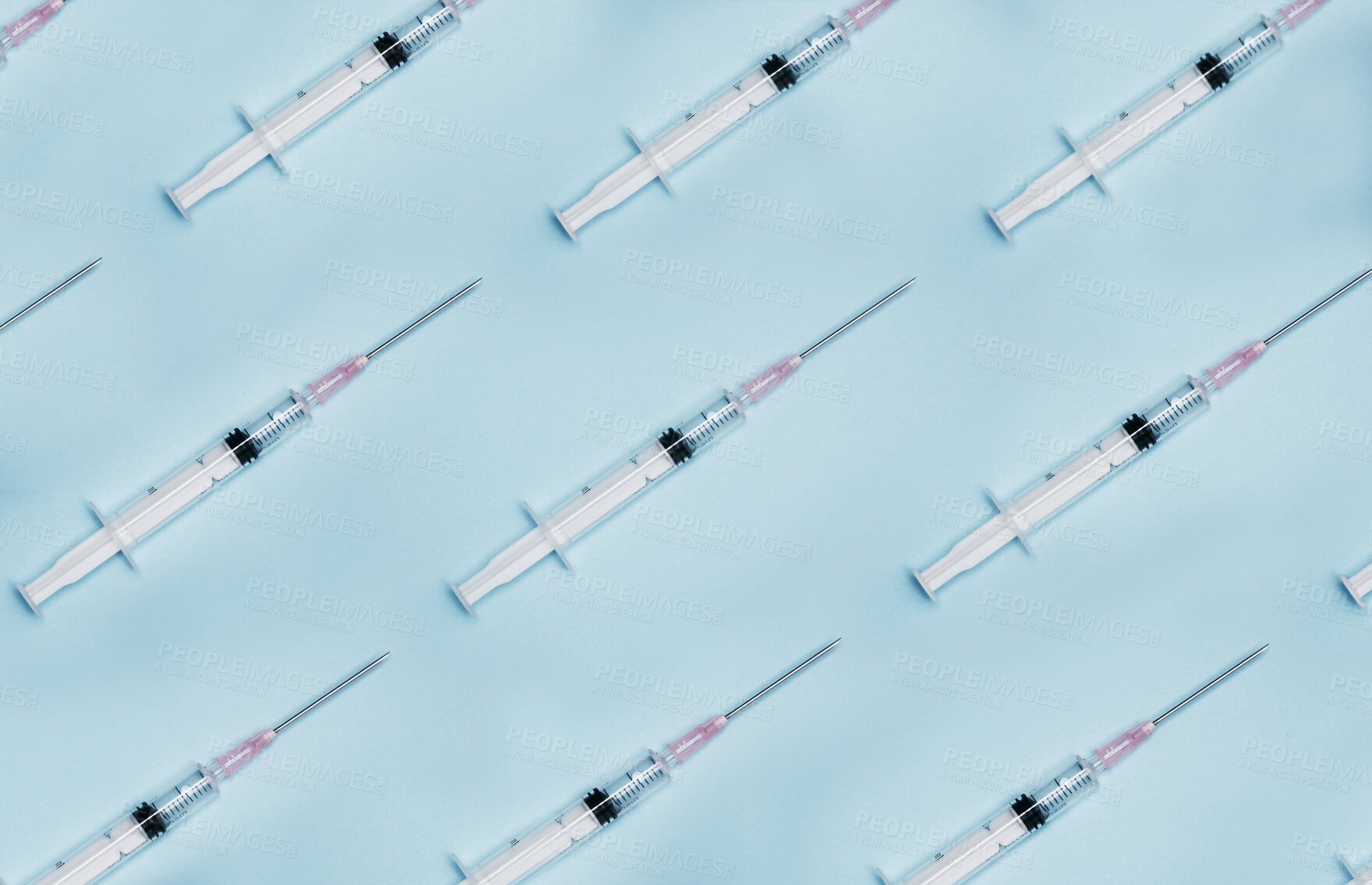 Buy stock photo Shot of a group of syringes against a blue background