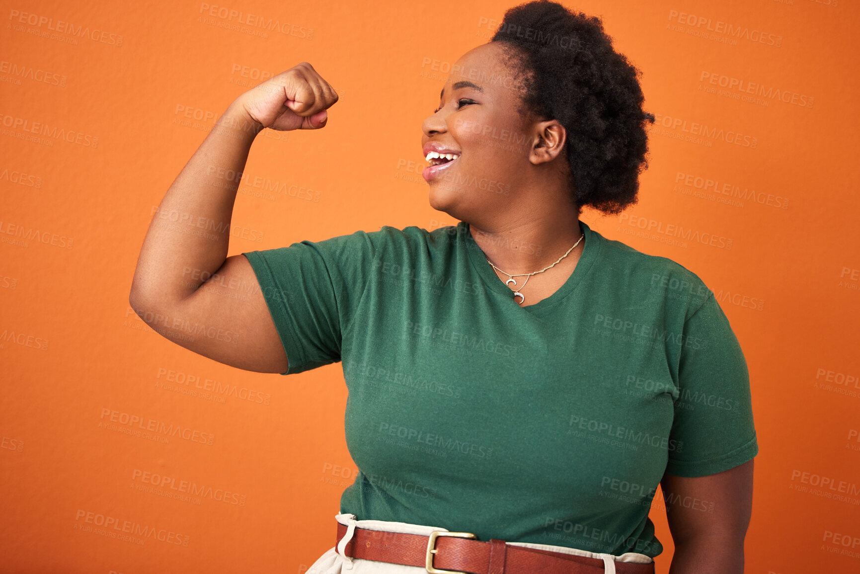 Buy stock photo Black woman, power and smile in orange background with arm flex for leader, gender equality and confident. Happy, proud and fist of girl for success, tough and strength in studio for empowerment