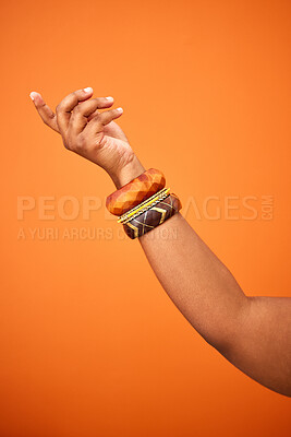 Buy stock photo Shot of an unrecognizable person pointing against an orange background