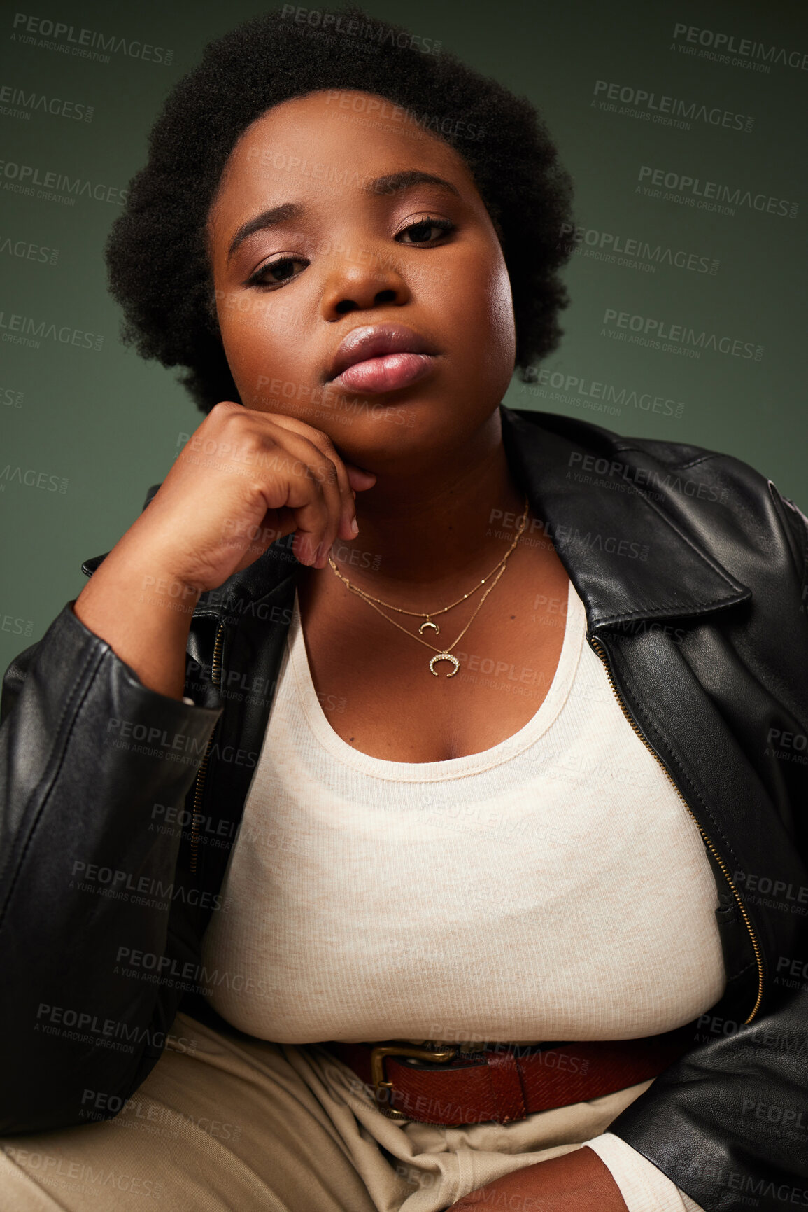 Buy stock photo Studio shot of a beautiful young woman posing against a green background