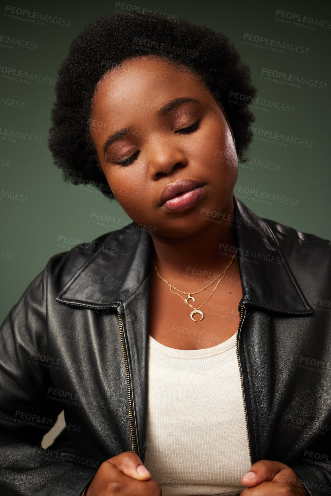 Buy stock photo Studio shot of a beautiful young woman posing against a green background