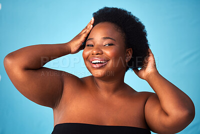 Buy stock photo Black woman, blue background or makeup in portrait or hands for aesthetics, skin with glow for wellness. Female person, plus size or afro with haircare and cosmetics, natural shine with confidence