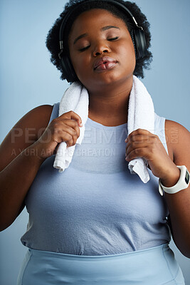 Buy stock photo Studio shot of an athletic young woman posing against a blue background