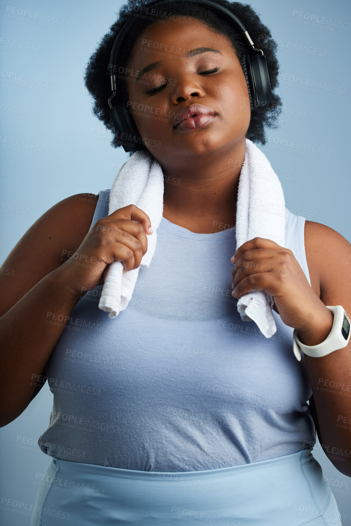 Buy stock photo Studio shot of an athletic young woman posing against a blue background