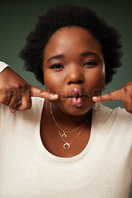 Buy stock photo Comic, black woman and funny fish face in studio for comedy or joke isolated on green background. Portrait, lips and crazy model with facial expression, goofy or silly young plus size African student