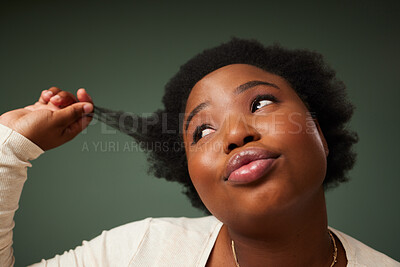 Buy stock photo Shot of an attractive young woman feeling flirty while posing against a green background in the studio