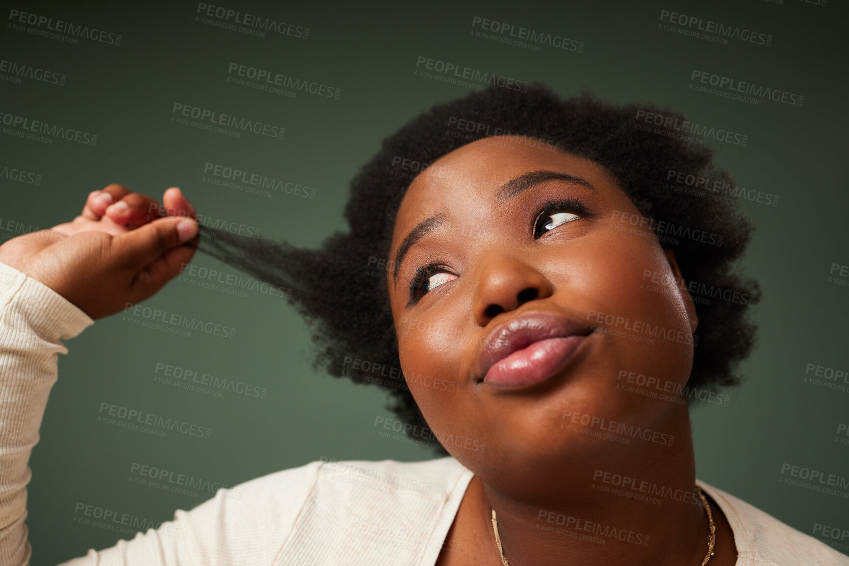 Buy stock photo Shot of an attractive young woman feeling flirty while posing against a green background in the studio