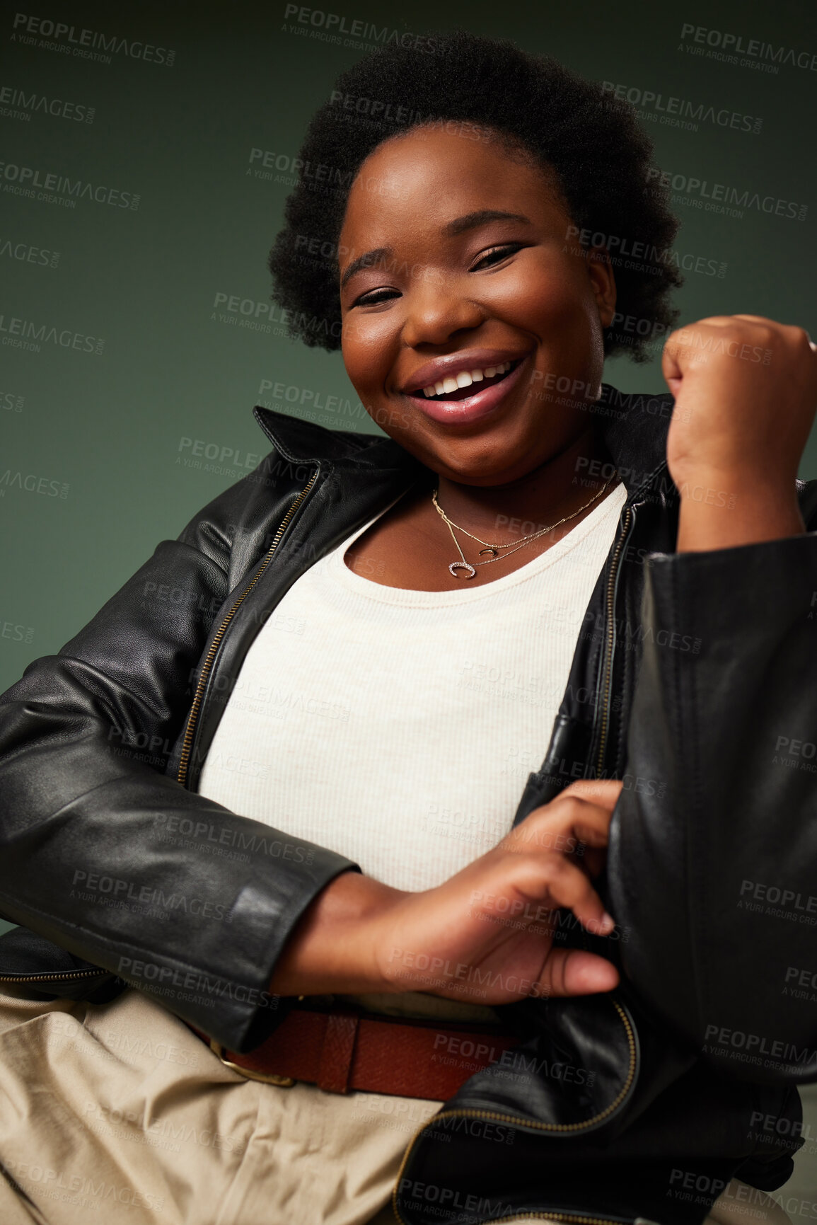 Buy stock photo Happy, african woman and fashion with leather jacket for plus size aesthetic outfit isolated in studio. Female person, smile and portrait with edgy clothes for pride and style on green background