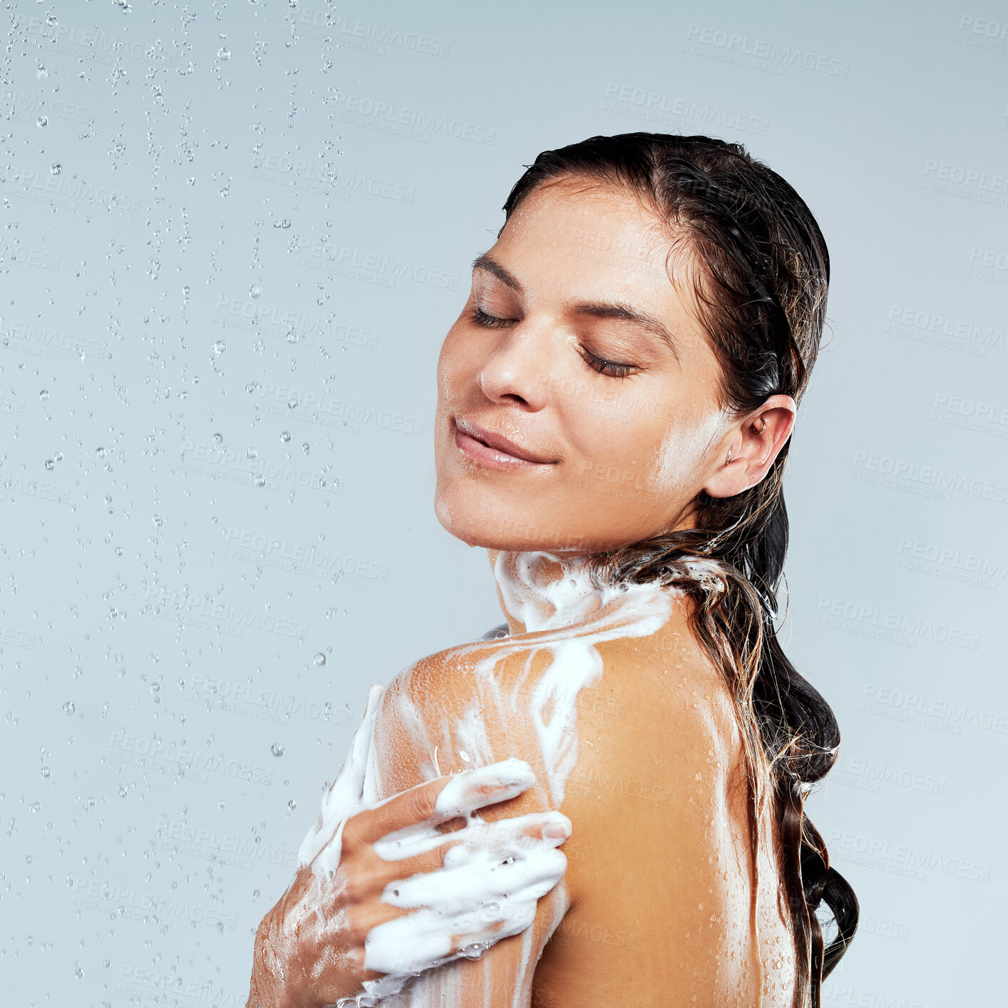 Buy stock photo Studio, shower or calm girl washing for skincare, body hygiene or cleaning with soap. Water, white background or wet woman with wellness or foam for beauty, grooming or cleansing for morning routine