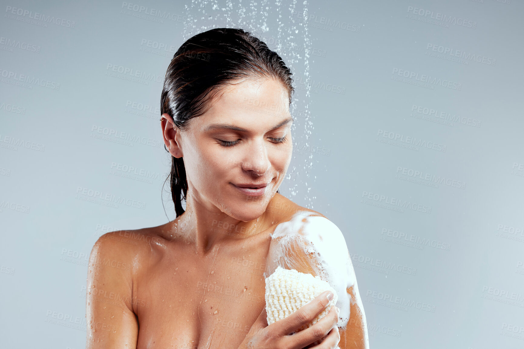 Buy stock photo Soap, cleaning or girl in shower for body hygiene, skincare or washing with wellness, scrub or water. Relax, grey background or woman in studio with natural liquid for beauty, health or wellbeing