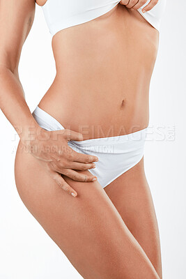 Buy stock photo Shot of a woman in her underwear against a studio background