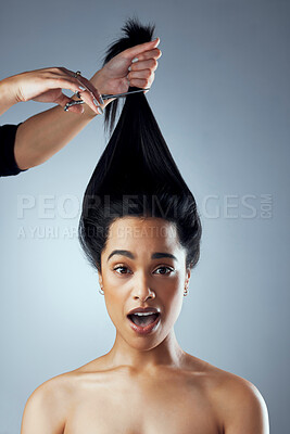 Buy stock photo Studio shot of  young woman getting her hair cut against a grey background