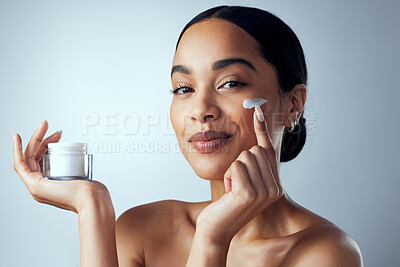 Buy stock photo Face cream, skincare and woman in studio for dermatology, wellness and hydration on grey background. Portrait, sunscreen and lady model relax with collagen, mask and lotion, beauty or facial product