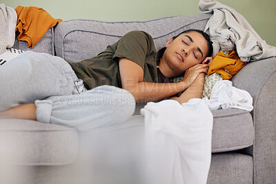 Buy stock photo Shot of a young woman sleeping on the couch at home