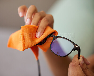 Buy stock photo Shot of an unrecognizable person cleaning glasses at home