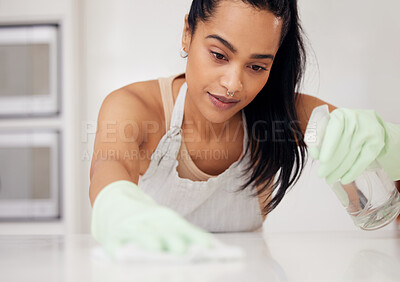 Buy stock photo Shot of a young woman cleaning a counter at home