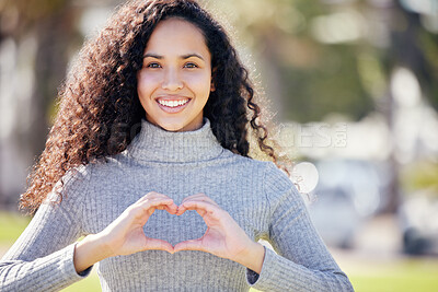 Buy stock photo Portrait, heart sign and woman in park, support and outdoor with symbol for love, promotion and sign. Face, happy person and girl with hand gesture, kindness and thank you with icon, peace and trust