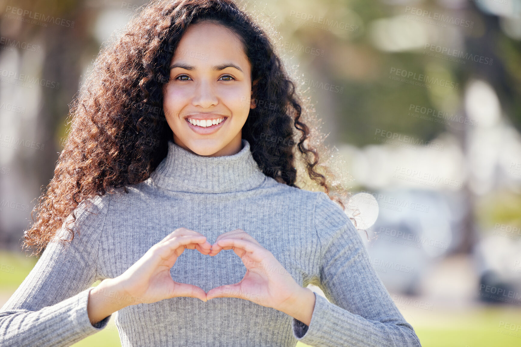 Buy stock photo Portrait, heart sign and woman in park, support and outdoor with symbol for love, promotion and sign. Face, happy person and girl with hand gesture, kindness and thank you with icon, peace and trust