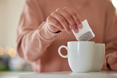 Buy stock photo Hand, morning or person with tea bag in home for energy, wellness or break to start day in house kitchen. Begin, prepare or closeup of mug on counter in winter for warm beverage or drink in apartment