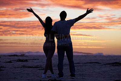Buy stock photo Sunset sky, freedom and couple on beach with silhouette, romance and travel holiday together for outdoor adventure. Love, man and woman embrace on evening date with nature, ocean or tropical vacation