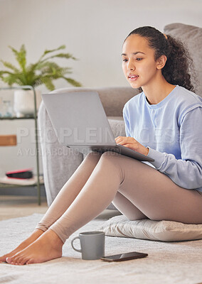 Buy stock photo Cropped shot of an attractive young woman using her laptop at home