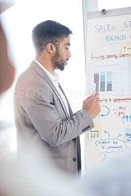 Buy stock photo Shot of a young businessman doing a presentation at work