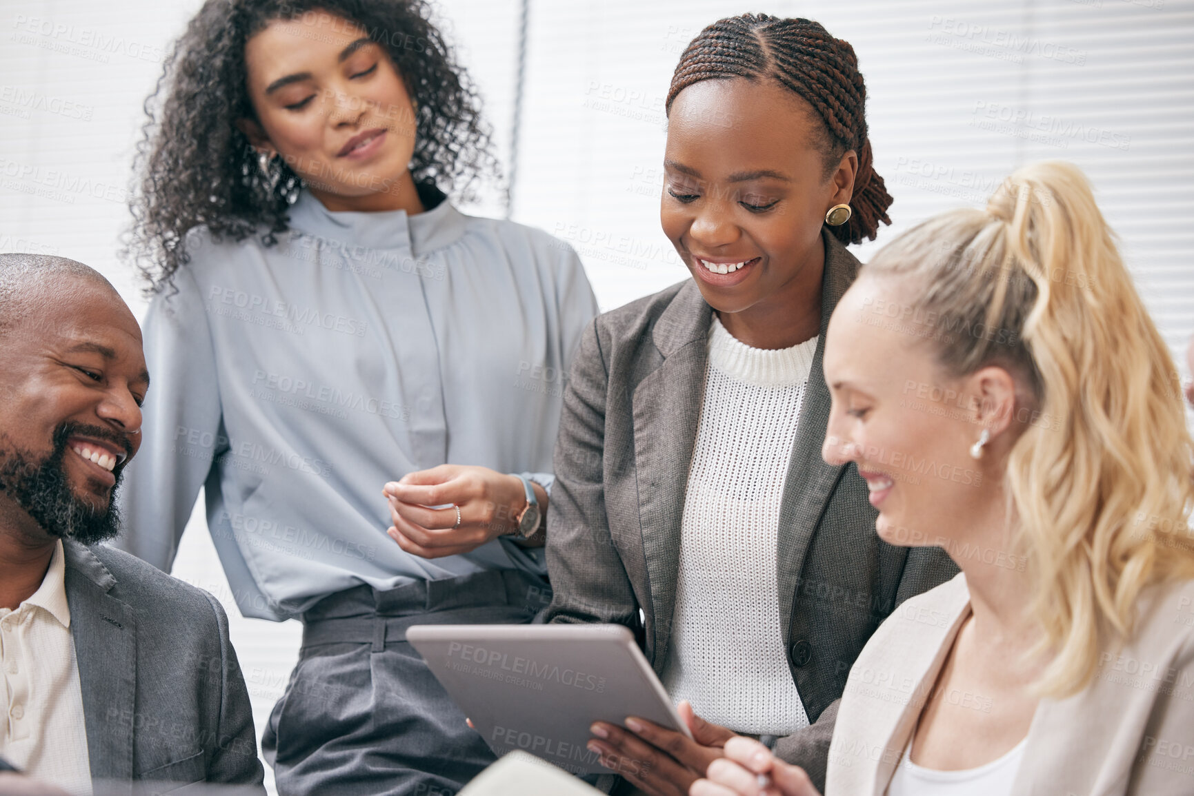 Buy stock photo Cropped shot of a group of white collar businesspeople looking at a tablet during a meeting in the boardroom