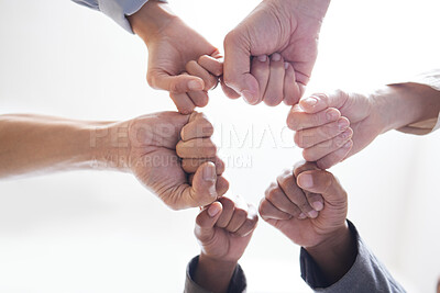 Buy stock photo Hands, business people and fist in circle, office and team building for solidarity in low angle. Colleagues, unity and connect for support or trust at work, white background and staff community 