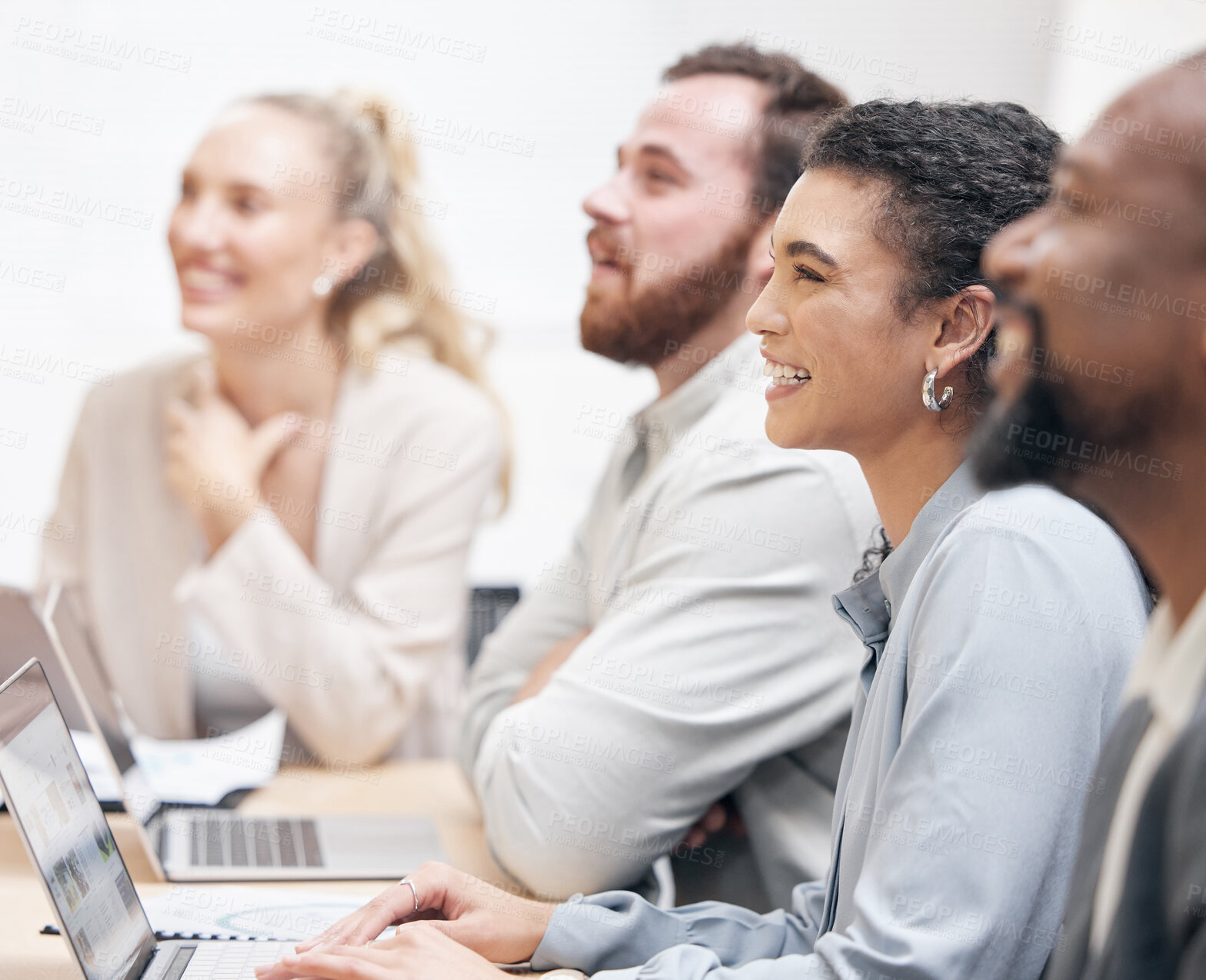 Buy stock photo Cropped shot of an attractive young businesswoman and her colleagues sitting in the boardroom during a meeting