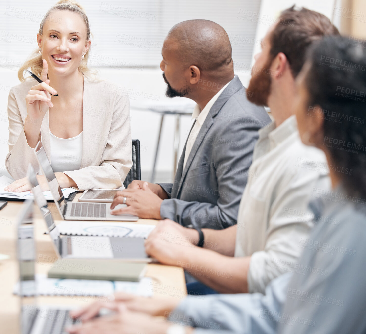 Buy stock photo Cropped shot of an attractive young businesswoman addressing her colleagues during a meeting in the boardroom