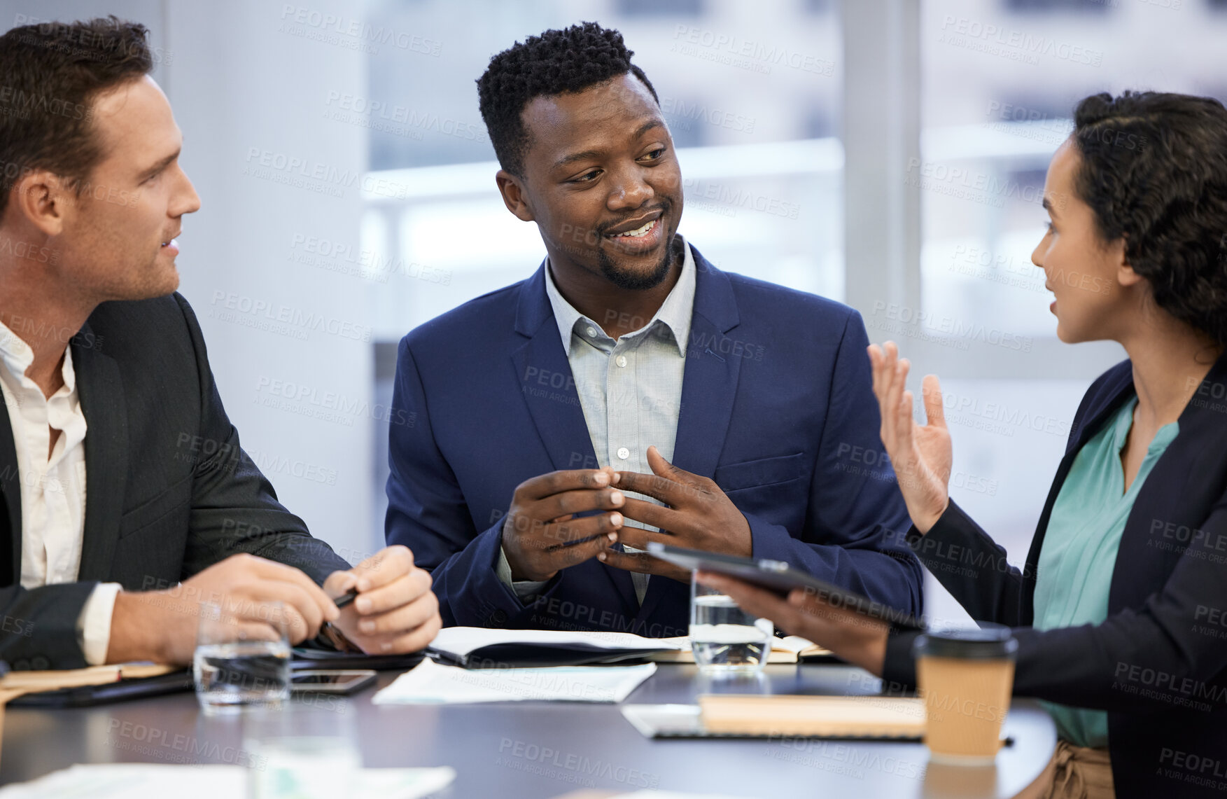 Buy stock photo Cropped shot of a group of white collar workers meeting in the boardroom