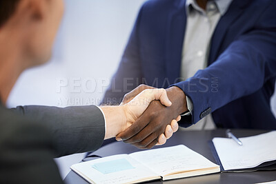 Buy stock photo High angle shot two unrecognizable businesspeople shaking hands during a meeting in the boardroom