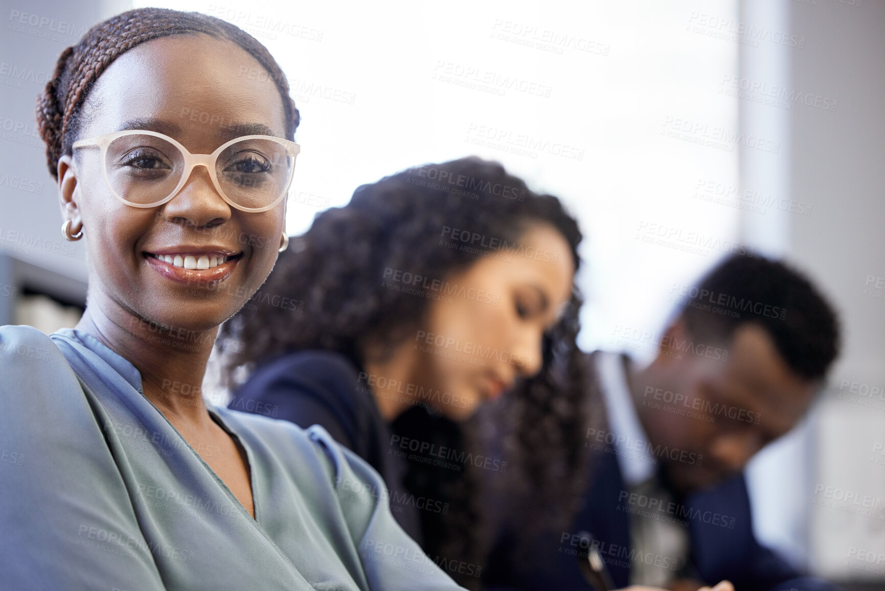 Buy stock photo Cropped portrait of an attractive young businesswoman sitting in the boardroom with her colleagues during a meeting